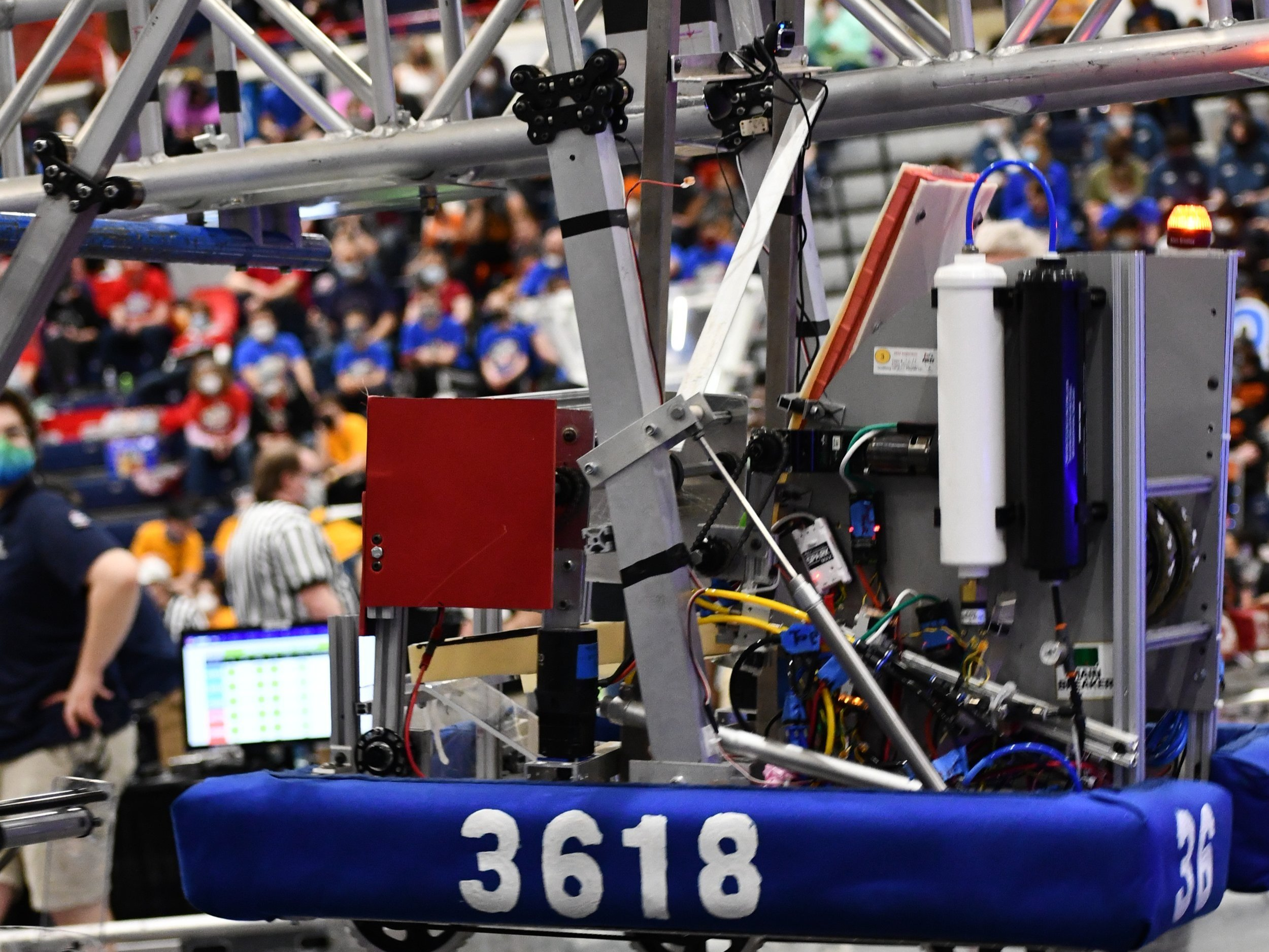 A robot hanging on a set of metal bars.